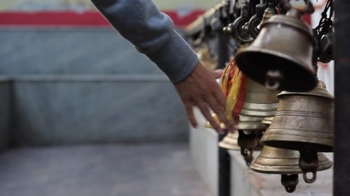 Hand Rings Bells at Temple
