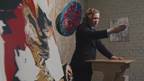 Art Gallery Speaker Gesturing During Presentation