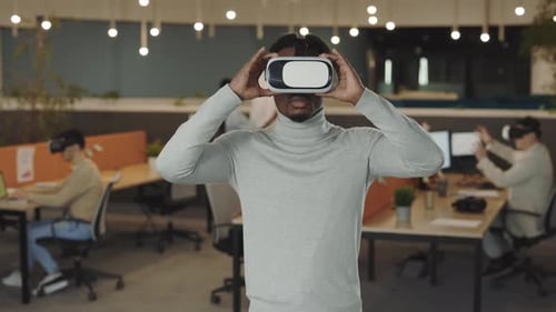 Office Male Worker Wearing a VR Headset Virtual Reality Concept