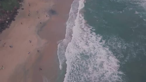 Busy Varkala Beach during holiday times in Kerala, India. Aerial drone view
