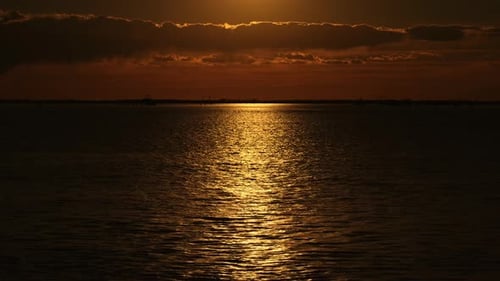 Boat Sails in Venetian Lagoon with Sunlight Reflection