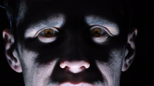 Vampire Looks at the Camera in the Dark