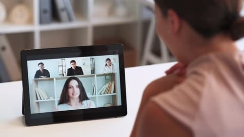 Woman Attends Virtual Meeting Using Tablet
