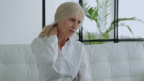 Older Woman Massaging Her Own Neck