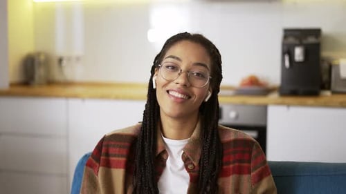 Smiling Woman with Braids at Home