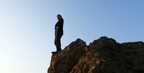 Business Man Standing On Cliff