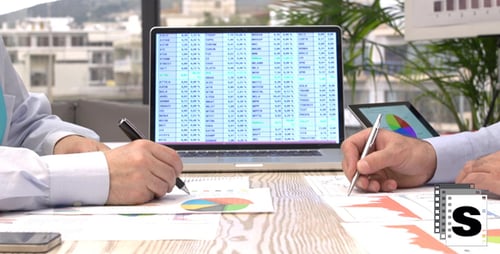 Businessmen Analyze Data in Bright Urban Office