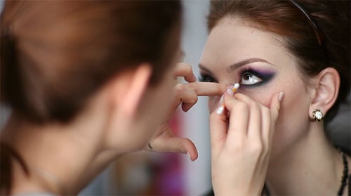 Makeup Artist Applying Eye Makeup to Woman