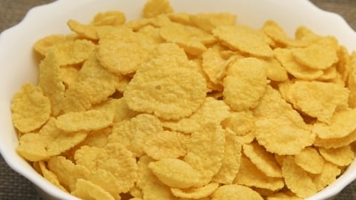 Crispy Corn Flakes in White Bowl for Breakfast