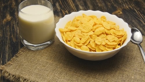 Cornflakes and Milk for Breakfast on Wooden Table