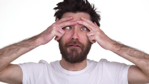 Man Making Funny Faces Up Close in Studio