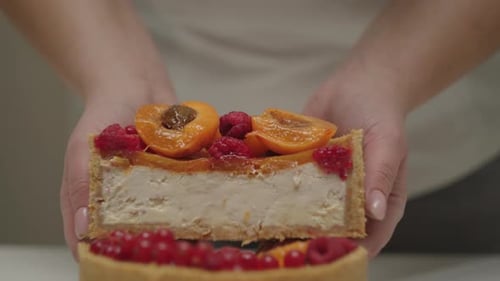 Cheesecake Slice Topped with Apricots and Raspberries