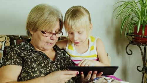 Grandmother and Grandchild Using a Tablet Together