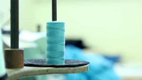 Close Up of Blue Thread Spool on Sewing Machine