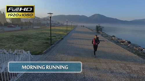 Woman Jogging on a Coastal Path in Daytime