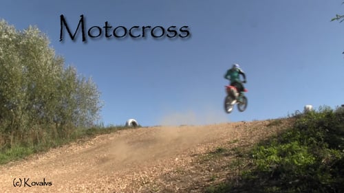 Motocross Racer Jumping Over Hill on Motorcycle