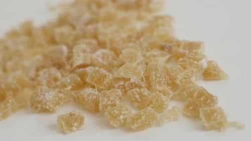 Pile of cooked and candied ginger root close-up 4K 2160p 30fps UltraHD panning footage - Crystalliz