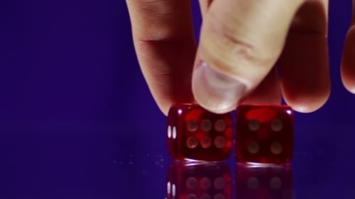 Playing Red Casino Dice Cubes On a Glass Table.