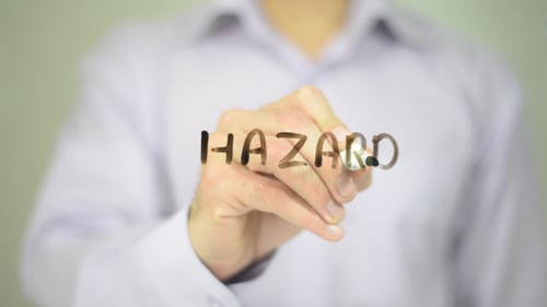 Hand Writes Hazard on Transparent Surface