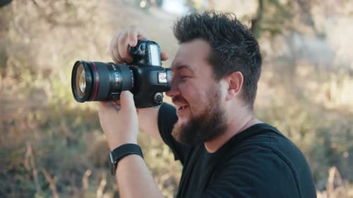 Bearded Man Taking Photos with DSLR Camera