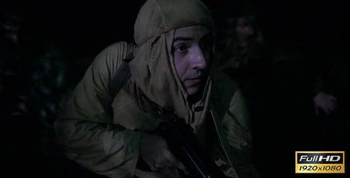 Soldiers Crawl Through Field on Covert Night Mission