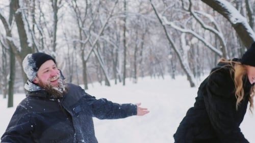 A Couple Having Fun In The Winter Forest
