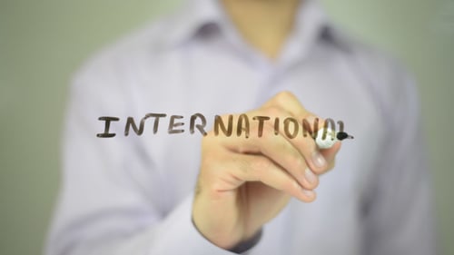 Hand Writing International with a Black Marker