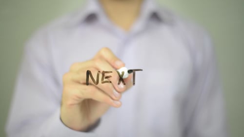 Hand Writing "Next" on Clear Surface