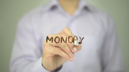 Man Writes Monday with Marker on Clear Surface