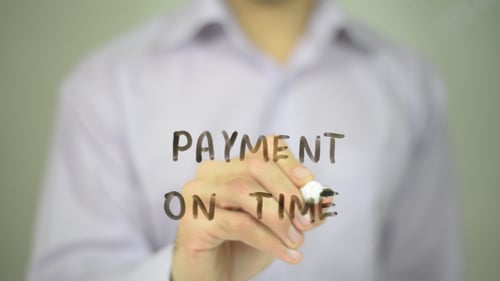 Writing Payment on Time on Clear Surface