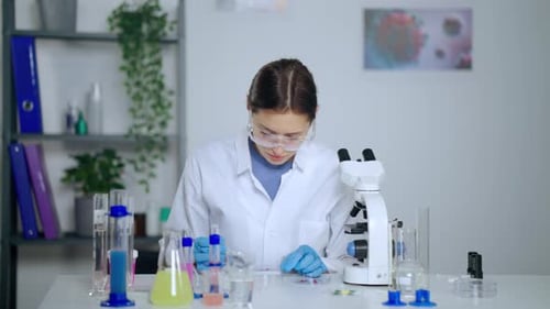 Woman Scientist Doing Lab Work With Microscope