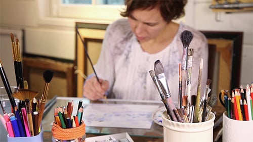 Female Artist Painting at Art Studio Table