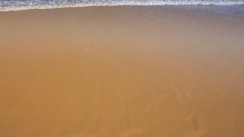 Gentle Waves Washing Ashore on a Sandy Beach