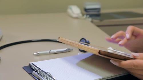 Woman using Tablet in a Doctor's Office