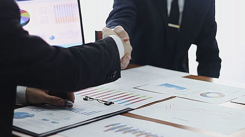 Business People Discussing Charts and Graphs in Office