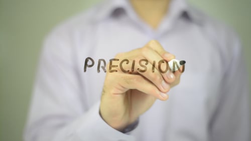 Hand Writes Word Precision on Translucent Surface