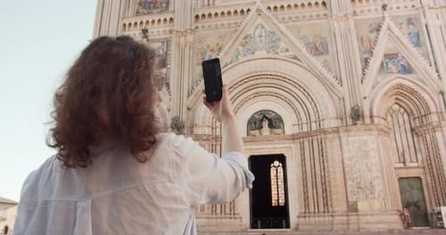 Beautiful Woman using Mobile Phone while have a walk