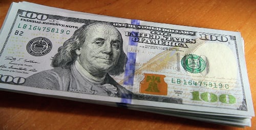 Stack of One Hundred Dollar Bills on Wood