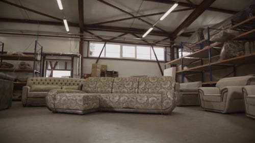 Woman In Work Uniform Come To a Sofa And Take Part Of In Furniture Factory