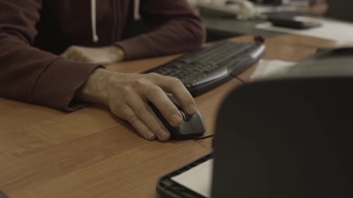Hand Using Computer Mouse in Office Workplace