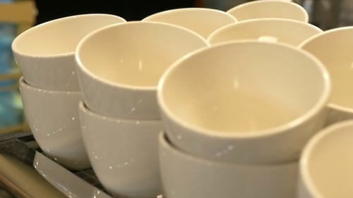 Neat Rows of White Coffee Cups Stacked High