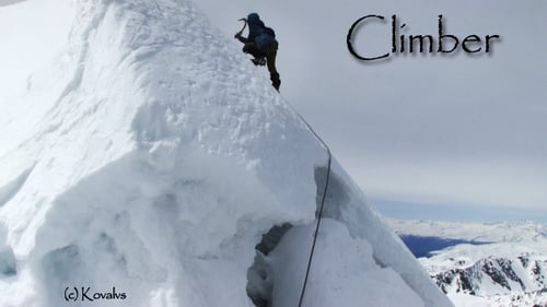 Lone Climber Ascends Snowy Mountain Peak in Winter
