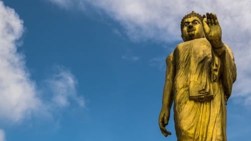 Big Gold Buddha Against Blue Sky