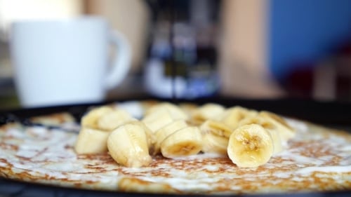 Pancake Topped with Banana and Chocolate Sauce