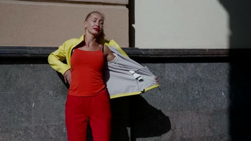 Fashionable Woman Posing on City Street in Sunlight