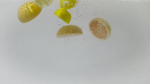 Halved Citrus Fruit Sinking in Water