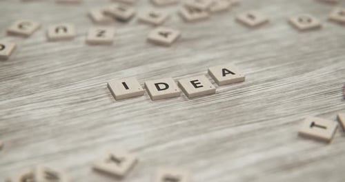 Scrabble Tiles Form Idea on Wooden Surface Animation