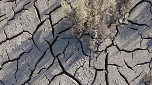 Flying over the cracked surface of a dry river