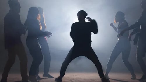 Group of Street Dancers Performing Different Moves on Dark Street