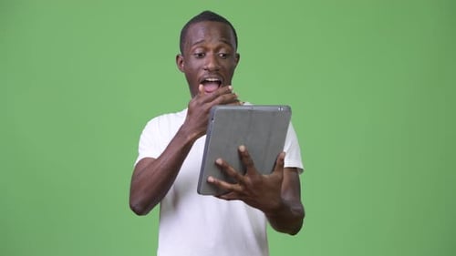 Young Adult Celebrating Using Tablet